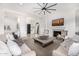 Spacious living room with neutral decor, fireplace, and large windows offering ample natural light at 17690 E Bronco Dr, Queen Creek, AZ 85142