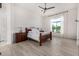Spacious and bright main bedroom with wood floors, a ceiling fan, and large windows at 17690 E Bronco Dr, Queen Creek, AZ 85142