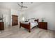 Light filled main bedroom with wood-look flooring, ceiling fan, and neutral décor at 17690 E Bronco Dr, Queen Creek, AZ 85142