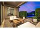 The covered patio features comfortable seating and overlooks the community pool surrounded by neatly trimmed hedges at 17690 E Bronco Dr, Queen Creek, AZ 85142