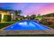 Gorgeous, modern swimming pool is surrounded by grass and landscaping, with plenty of room for entertaining at 17690 E Bronco Dr, Queen Creek, AZ 85142