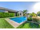 Backyard oasis featuring a pool with water feature, lush landscaping, and well-manicured lawn, offering a tranquil retreat at 17690 E Bronco Dr, Queen Creek, AZ 85142