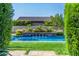 Beautiful pool with a water feature, framed by lush landscaping and manicured greenery, enhancing the outdoor space at 17690 E Bronco Dr, Queen Creek, AZ 85142