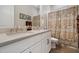 Bathroom featuring a double sink vanity with white cabinetry and decorative mirrors with a shower and tub at 18225 N 66Th Way, Phoenix, AZ 85054