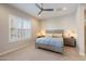 Calm bedroom with a neutral color palette, large window with shutters, and ceiling fan at 18225 N 66Th Way, Phoenix, AZ 85054