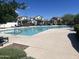 Sparkling community pool surrounded by lush landscaping and seating areas for residents at 18225 N 66Th Way, Phoenix, AZ 85054