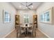 Cozy dining room featuring a round table, four chairs, a ceiling fan, and stylish decor at 18225 N 66Th Way, Phoenix, AZ 85054