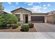 Charming home exterior with a well-maintained front yard and a two-car garage at 18225 N 66Th Way, Phoenix, AZ 85054