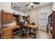 Bright home office featuring custom built-ins, a desk, and a comfortable chair for a productive workspace at 18225 N 66Th Way, Phoenix, AZ 85054