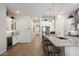 Open-concept kitchen featuring a long island, tile backsplash, stainless steel fridge, and modern lighting at 18225 N 66Th Way, Phoenix, AZ 85054