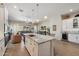 Open concept kitchen featuring a large granite island, stainless steel appliances, and modern white cabinetry at 18225 N 66Th Way, Phoenix, AZ 85054