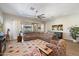 Spacious living room featuring a large sectional sofa, a ceiling fan, and access to the backyard at 18225 N 66Th Way, Phoenix, AZ 85054