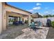 Relaxing covered patio boasts comfortable seating, BBQ, and shade, perfect for outdoor dining and entertainment at 18225 N 66Th Way, Phoenix, AZ 85054
