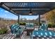 Inviting outdoor patio featuring comfortable lounge furniture and a stylish pergola for relaxing and entertaining at 18225 N 66Th Way, Phoenix, AZ 85054