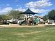 Community playground with grassy field, providing ample space for children to play at 18225 N 66Th Way, Phoenix, AZ 85054