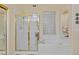 Bathroom featuring a shower and tub combination and glass block window at 1943 E Drake Dr, Tempe, AZ 85283