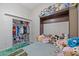 Cozy bedroom with closet storage, a built-in bed, and comfortable furnishings at 1943 E Drake Dr, Tempe, AZ 85283