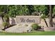 Community sign for The Oasis featuring a tiered waterfall and lush desert landscaping at 1943 E Drake Dr, Tempe, AZ 85283