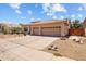 Single-story home with desert landscaping, a tile roof, two-car garage, and a paved driveway at 1943 E Drake Dr, Tempe, AZ 85283