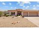 Desert landscaped home featuring a three-car garage and neutral stucco exterior at 1943 E Drake Dr, Tempe, AZ 85283