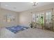 Bright living room with wood-look tile, blue rug, shuttered windows, and plant decor at 1943 E Drake Dr, Tempe, AZ 85283