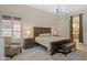 Elegant main bedroom with a king bed, stylish lamps, and wood-look flooring at 1943 E Drake Dr, Tempe, AZ 85283