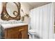 Charming bathroom with a decorative mirror, elegant vanity, and a bathtub with a shower curtain at 23119 W Papago St, Buckeye, AZ 85326
