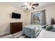 Bright bedroom with light-colored walls, wood-look floors, and a large window overlooking the backyard at 23119 W Papago St, Buckeye, AZ 85326