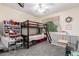 Cozy ' bedroom with a bunk bed, carpeted floors, and natural light from the window at 23119 W Papago St, Buckeye, AZ 85326