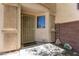 Covered entryway features a secure screen door, a window for natural light, and stone decorations at 23119 W Papago St, Buckeye, AZ 85326