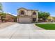 Charming two-story home with a well-maintained front yard and wide driveway leading to the attached two-car garage at 23119 W Papago St, Buckeye, AZ 85326