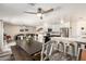 Open-concept living space with a dining area, modern kitchen, and living room featuring a ceiling fan for added comfort at 23119 W Papago St, Buckeye, AZ 85326