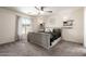 Inviting main bedroom with neutral tones, a large window, modern lighting, and plush carpeting at 23119 W Papago St, Buckeye, AZ 85326