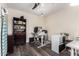 Dedicated home office space with wood floors, built-in shelving, and a functional desk setup at 23119 W Papago St, Buckeye, AZ 85326