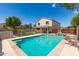 Inviting backyard pool and spa with lush landscaping, covered patio, and privacy fence at 23119 W Papago St, Buckeye, AZ 85326