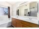 Bright bathroom with dual sinks, modern fixtures, and a separate tub and shower at 2356 N Glenview --, Mesa, AZ 85213
