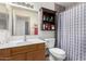 Traditional bathroom with wood vanity, medicine cabinet, and shower with patterned curtain at 2356 N Glenview --, Mesa, AZ 85213