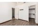 This bedroom features wood-look tile flooring, a coat rack, and a walk-in closet at 2356 N Glenview --, Mesa, AZ 85213