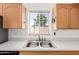 Bright kitchen with stainless steel sink, updated faucet, and natural light, creating a modern culinary space at 2356 N Glenview --, Mesa, AZ 85213