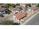 Aerial view showcases a home with a red tile roof, fenced yard, detached shed, and a glimpse of a pool at 2358 E Peach Tree Dr, Chandler, AZ 85249
