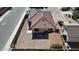 Aerial view of a house with red tile roof, gravel yard, detached shed, and block wall fence at 2358 E Peach Tree Dr, Chandler, AZ 85249