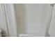 Clean shower and tub combo with white tile and a neutral curtain provides an inviting space at 2358 E Peach Tree Dr, Chandler, AZ 85249