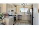 Modern kitchen with stainless steel appliances, white cabinets, and countertops, accented by neutral backsplash and flooring at 2358 E Peach Tree Dr, Chandler, AZ 85249