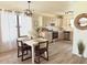 Kitchen and dining area featuring stainless steel appliances, white cabinets, and modern dining set at 2358 E Peach Tree Dr, Chandler, AZ 85249