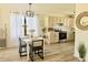Kitchen and dining area featuring stainless steel appliances, white cabinets, and modern dining set at 2358 E Peach Tree Dr, Chandler, AZ 85249