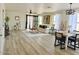 Bright living room featuring an open floor plan and light wood floors, complemented by neutral decor and ample natural light at 2358 E Peach Tree Dr, Chandler, AZ 85249