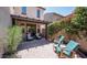 Paver patio with seating area and mature landscaping providing shade and privacy in the backyard at 2418 W Jake Hvn, Phoenix, AZ 85085