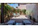 Private backyard with lush landscaping and patio seating area at 2418 W Jake Hvn, Phoenix, AZ 85085