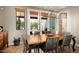 Elegant dining area featuring a stylish chandelier and backyard access through the double doors at 2418 W Jake Hvn, Phoenix, AZ 85085