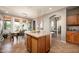 Open kitchen area with an island, modern lighting, stainless appliances, and dining area at 2418 W Jake Hvn, Phoenix, AZ 85085